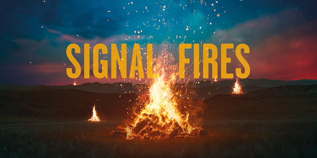 A small bonfire in the middle of a field at night. Text overlay: Signal Fires